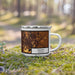 Right View Custom Omaha Nebraska Map Enamel Mug in Ember on Grass With Trees in Background
