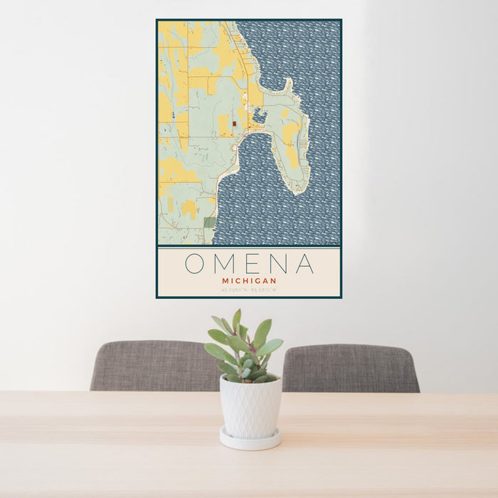 24x36 Omena Michigan Map Print Portrait Orientation in Woodblock Style Behind 2 Chairs Table and Potted Plant