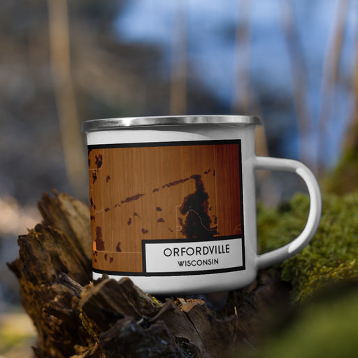 Right View Custom Orfordville Wisconsin Map Enamel Mug in Ember on Grass With Trees in Background