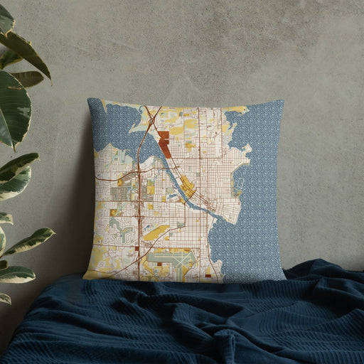 Custom Oshkosh Wisconsin Map Throw Pillow in Woodblock on Bedding Against Wall