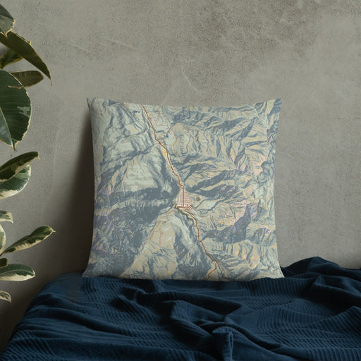 Custom Ouray Colorado Map Throw Pillow in Woodblock on Bedding Against Wall