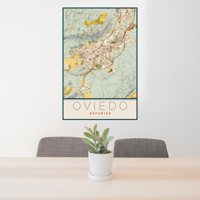 24x36 Oviedo Asturias Map Print Portrait Orientation in Woodblock Style Behind 2 Chairs Table and Potted Plant