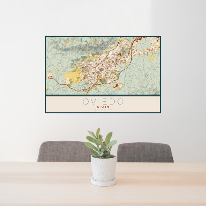 24x36 Oviedo Spain Map Print Lanscape Orientation in Woodblock Style Behind 2 Chairs Table and Potted Plant