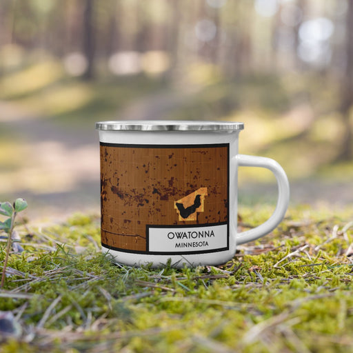 Right View Custom Owatonna Minnesota Map Enamel Mug in Ember on Grass With Trees in Background