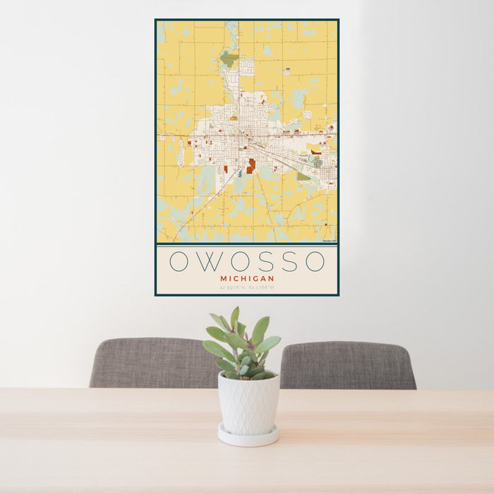 24x36 Owosso Michigan Map Print Portrait Orientation in Woodblock Style Behind 2 Chairs Table and Potted Plant