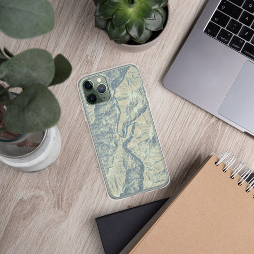 Custom Oxbow Oregon Map Phone Case in Woodblock on Table with Laptop and Plant