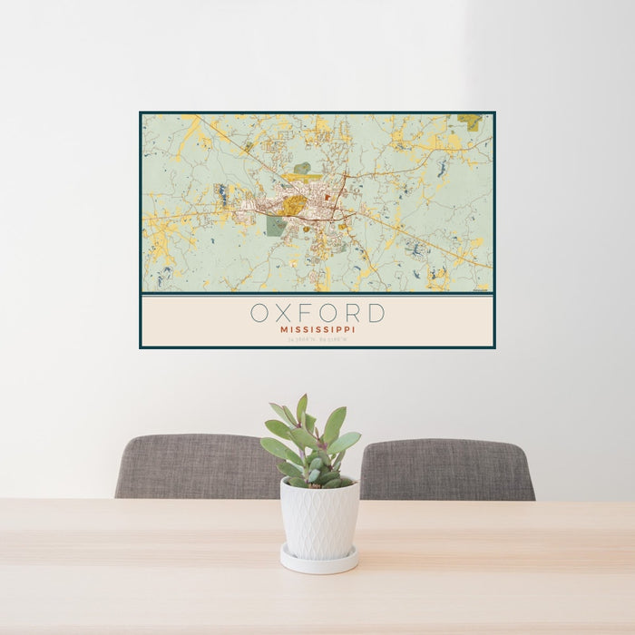 24x36 Oxford Mississippi Map Print Landscape Orientation in Woodblock Style Behind 2 Chairs Table and Potted Plant