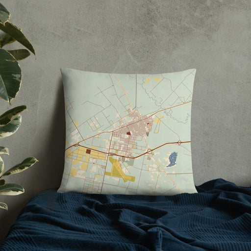 Custom Pecos Texas Map Throw Pillow in Woodblock on Bedding Against Wall