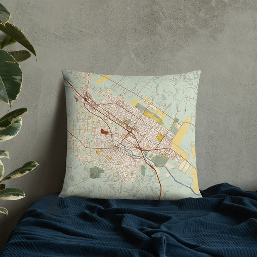 Custom Petaluma California Map Throw Pillow in Woodblock on Bedding Against Wall
