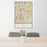 24x36 Pflugerville Texas Map Print Portrait Orientation in Woodblock Style Behind 2 Chairs Table and Potted Plant