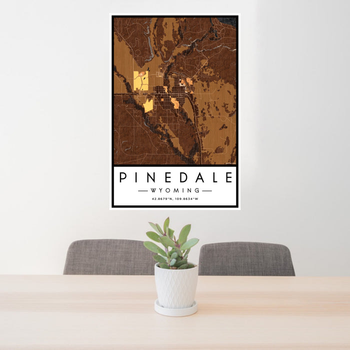 24x36 Pinedale Wyoming Map Print Portrait Orientation in Ember Style Behind 2 Chairs Table and Potted Plant