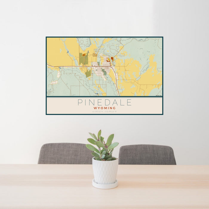24x36 Pinedale Wyoming Map Print Lanscape Orientation in Woodblock Style Behind 2 Chairs Table and Potted Plant