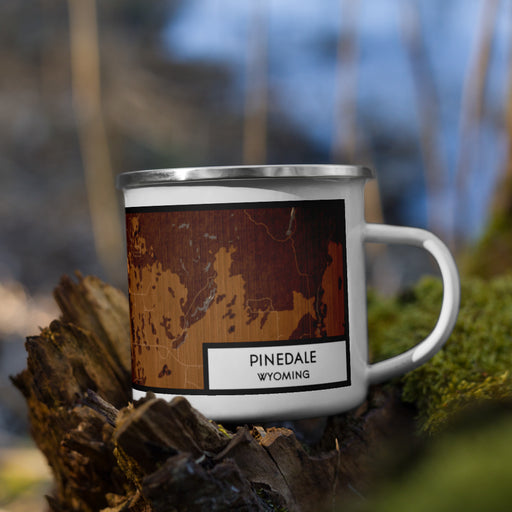 Right View Custom Pinedale Wyoming Map Enamel Mug in Ember on Grass With Trees in Background