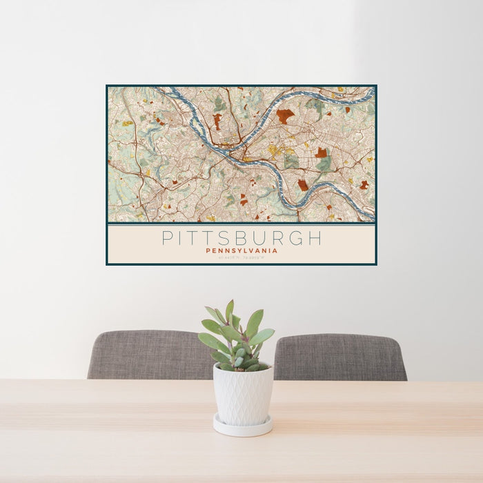 24x36 Pittsburgh Pennsylvania Map Print Landscape Orientation in Woodblock Style Behind 2 Chairs Table and Potted Plant