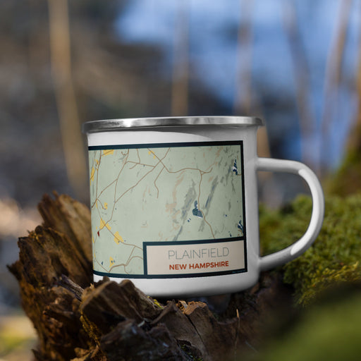 Right View Custom Plainfield New Hampshire Map Enamel Mug in Woodblock on Grass With Trees in Background
