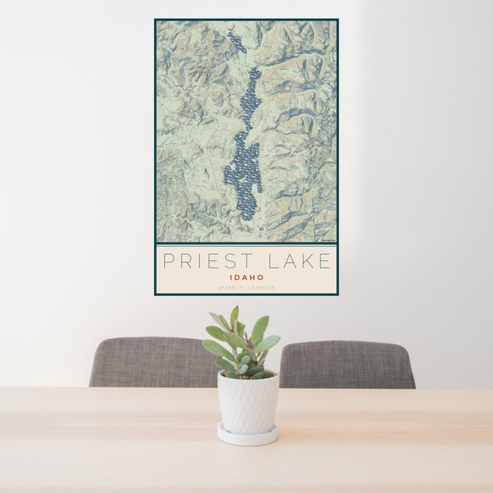 24x36 Priest Lake Idaho Map Print Portrait Orientation in Woodblock Style Behind 2 Chairs Table and Potted Plant