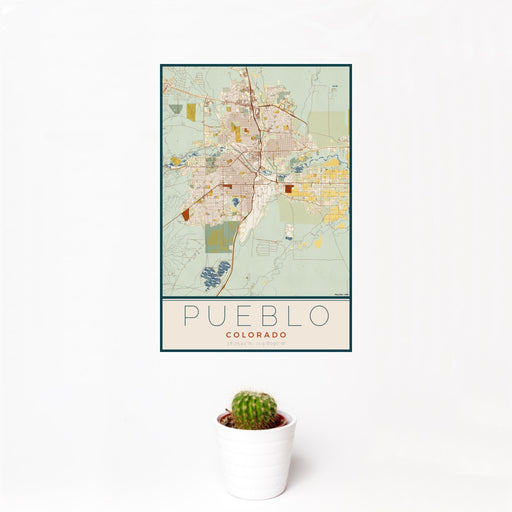 12x18 Pueblo Colorado Map Print Portrait Orientation in Woodblock Style With Small Cactus Plant in White Planter