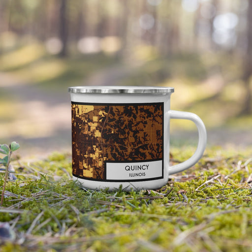 Right View Custom Quincy Illinois Map Enamel Mug in Ember on Grass With Trees in Background