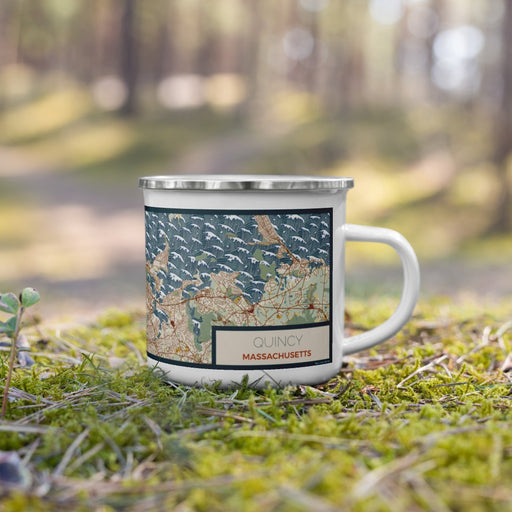 Right View Custom Quincy Massachusetts Map Enamel Mug in Woodblock on Grass With Trees in Background