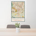 24x36 Raleigh North Carolina Map Print Portrait Orientation in Woodblock Style Behind 2 Chairs Table and Potted Plant