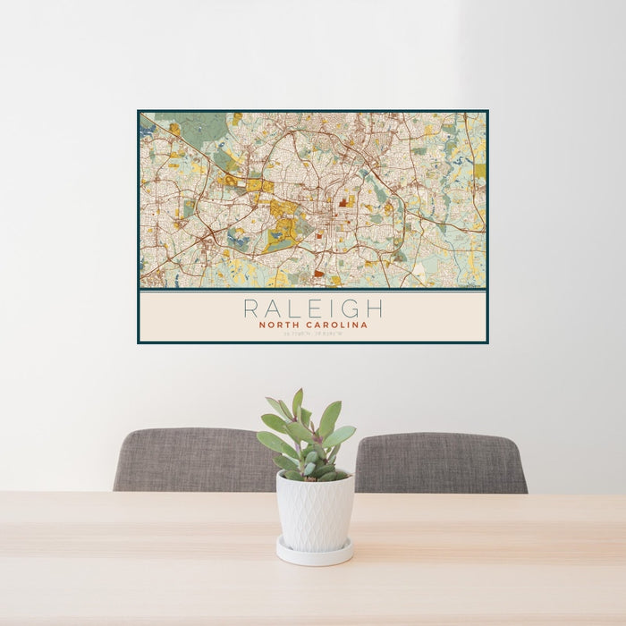 24x36 Raleigh North Carolina Map Print Landscape Orientation in Woodblock Style Behind 2 Chairs Table and Potted Plant