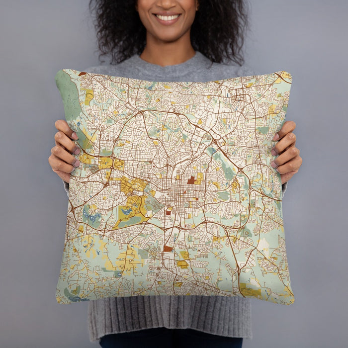 Person holding 18x18 Custom Raleigh North Carolina Map Throw Pillow in Woodblock