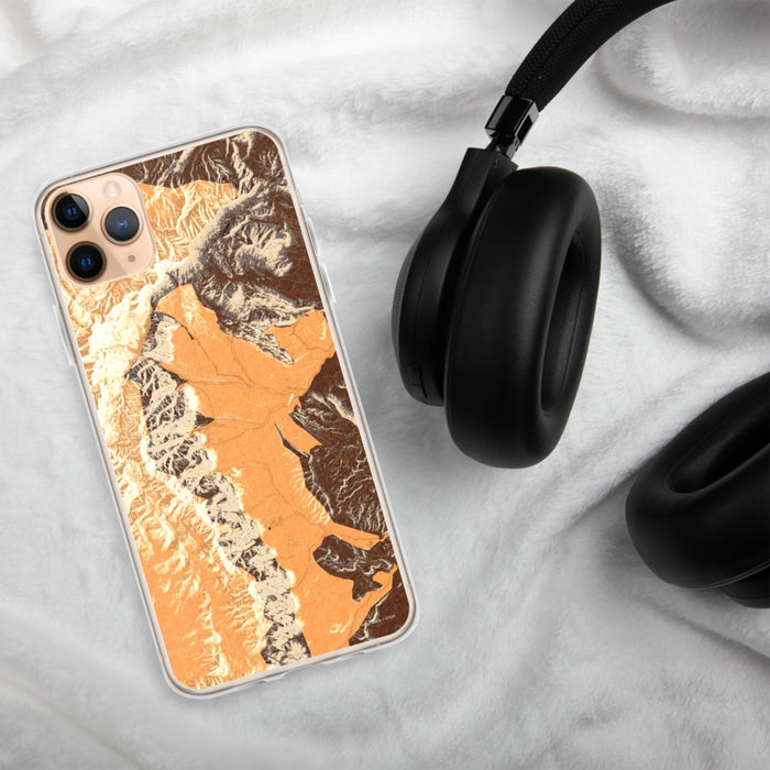 Custom Red Rock Canyon Nevada Map Phone Case in Ember on Table with Black Headphones