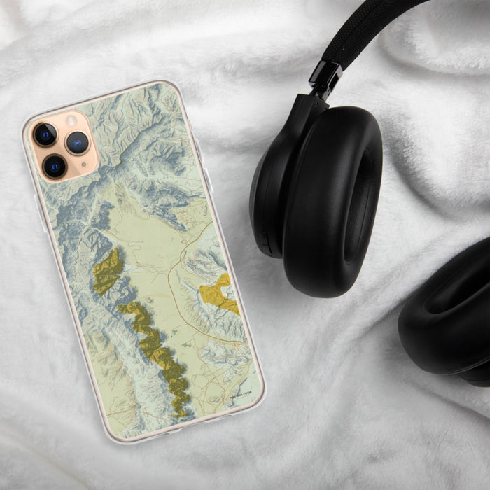 Custom Red Rock Canyon Nevada Map Phone Case in Woodblock on Table with Black Headphones