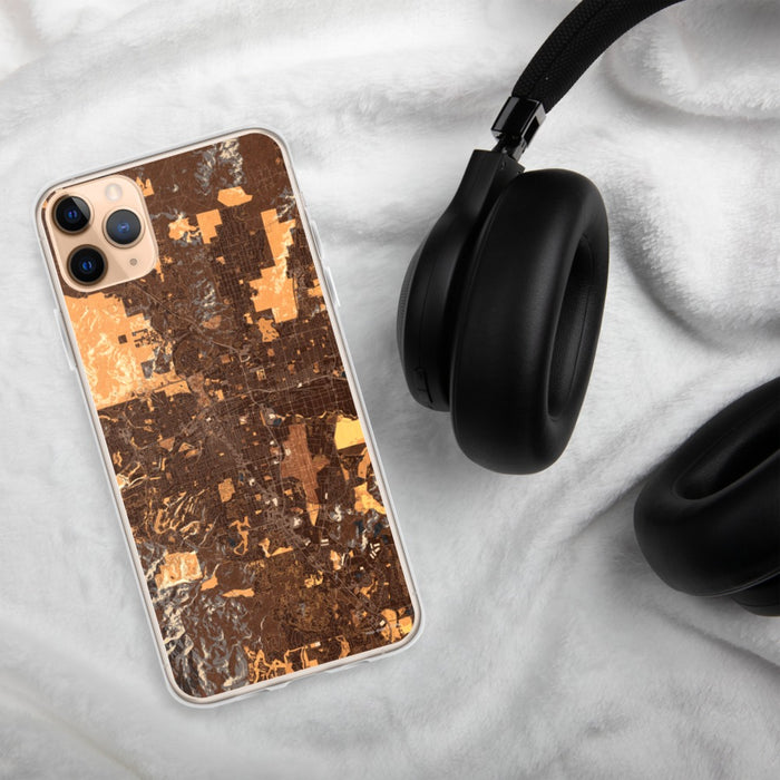 Custom Reno Nevada Map Phone Case in Ember on Table with Black Headphones