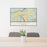 24x36 Ridgway Colorado Map Print Lanscape Orientation in Woodblock Style Behind 2 Chairs Table and Potted Plant