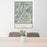 24x36 Riggins Idaho Map Print Portrait Orientation in Woodblock Style Behind 2 Chairs Table and Potted Plant