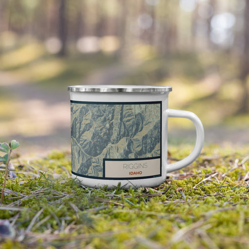 Right View Custom Riggins Idaho Map Enamel Mug in Woodblock on Grass With Trees in Background