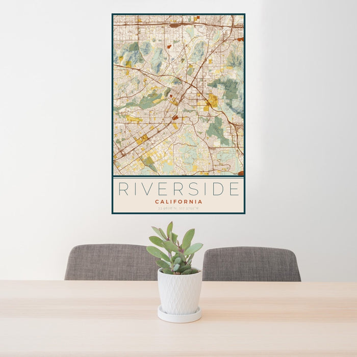 24x36 Riverside California Map Print Portrait Orientation in Woodblock Style Behind 2 Chairs Table and Potted Plant