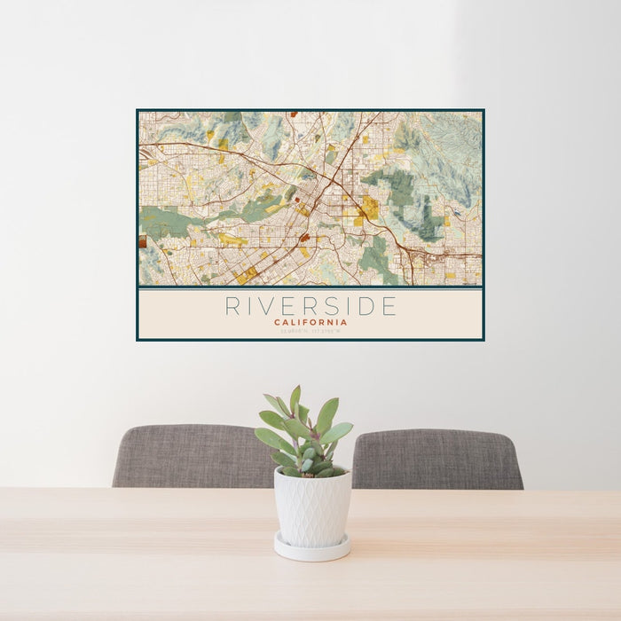24x36 Riverside California Map Print Landscape Orientation in Woodblock Style Behind 2 Chairs Table and Potted Plant