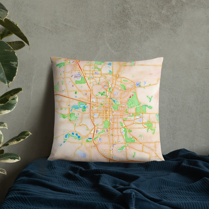 Custom Rochester Minnesota Map Throw Pillow in Watercolor on Bedding Against Wall