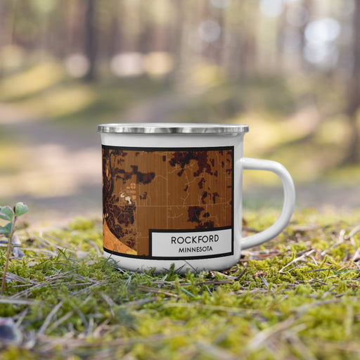 Right View Custom Rockford Minnesota Map Enamel Mug in Ember on Grass With Trees in Background