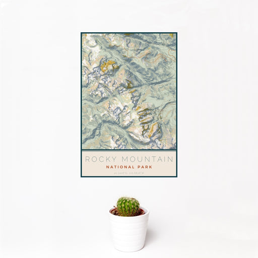 12x18 Rocky Mountain National Park Map Print Portrait Orientation in Woodblock Style With Small Cactus Plant in White Planter