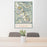 24x36 Rocky Mountain National Park Map Print Portrait Orientation in Woodblock Style Behind 2 Chairs Table and Potted Plant