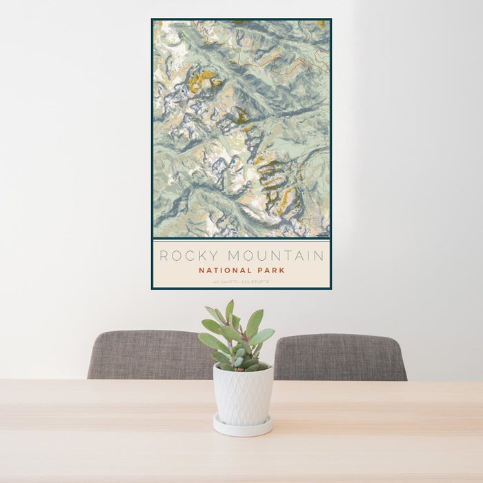 24x36 Rocky Mountain National Park Map Print Portrait Orientation in Woodblock Style Behind 2 Chairs Table and Potted Plant