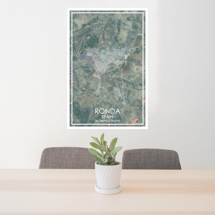 24x36 Ronda Spain Map Print Portrait Orientation in Afternoon Style Behind 2 Chairs Table and Potted Plant