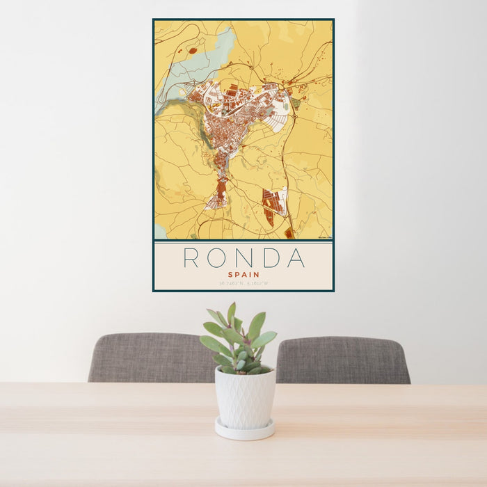 24x36 Ronda Spain Map Print Portrait Orientation in Woodblock Style Behind 2 Chairs Table and Potted Plant