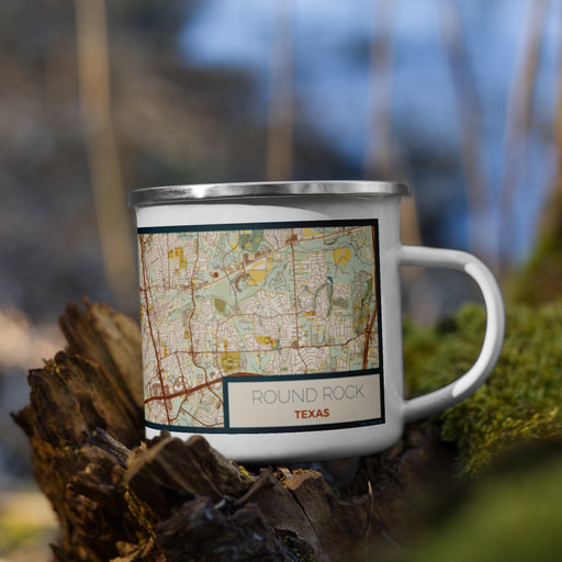 Right View Custom Round Rock Texas Map Enamel Mug in Woodblock on Grass With Trees in Background