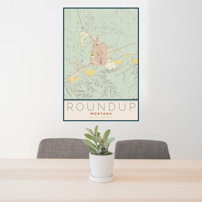 24x36 Roundup Montana Map Print Portrait Orientation in Woodblock Style Behind 2 Chairs Table and Potted Plant
