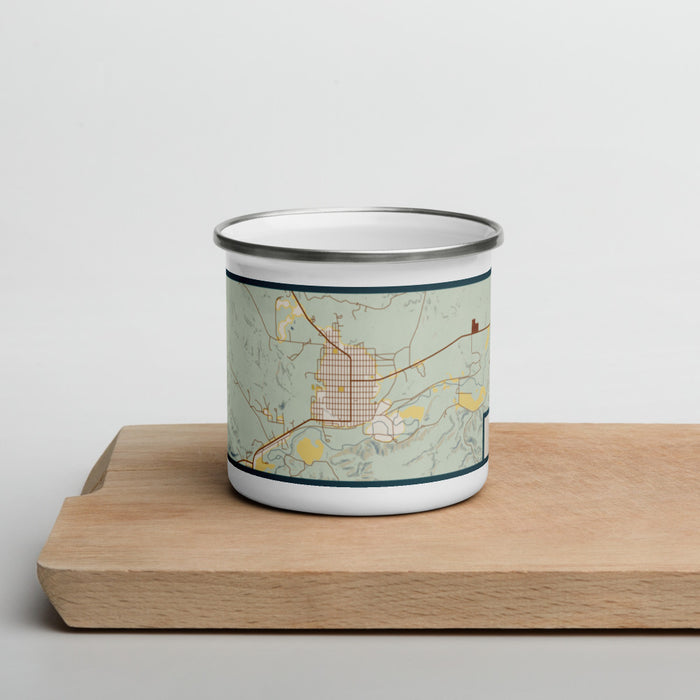 Front View Custom Roundup Montana Map Enamel Mug in Woodblock on Cutting Board