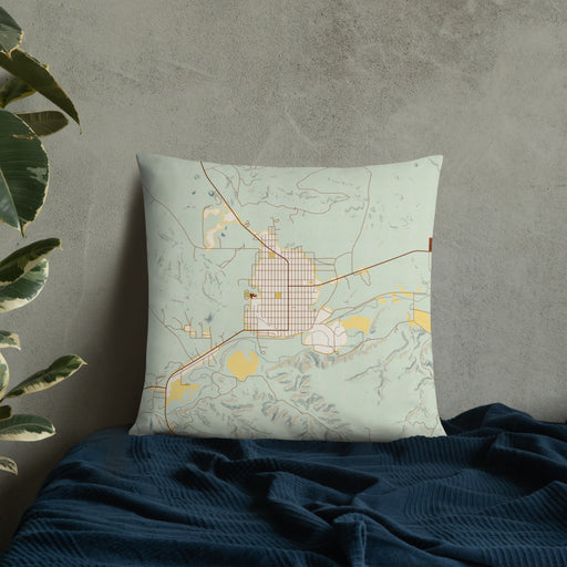 Custom Roundup Montana Map Throw Pillow in Woodblock on Bedding Against Wall