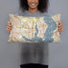 Person holding 20x12 Custom Rowlett Texas Map Throw Pillow in Woodblock
