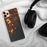 Custom Rye New York Map Phone Case in Ember on Table with Black Headphones