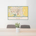 24x36 Saginaw Michigan Map Print Lanscape Orientation in Woodblock Style Behind 2 Chairs Table and Potted Plant