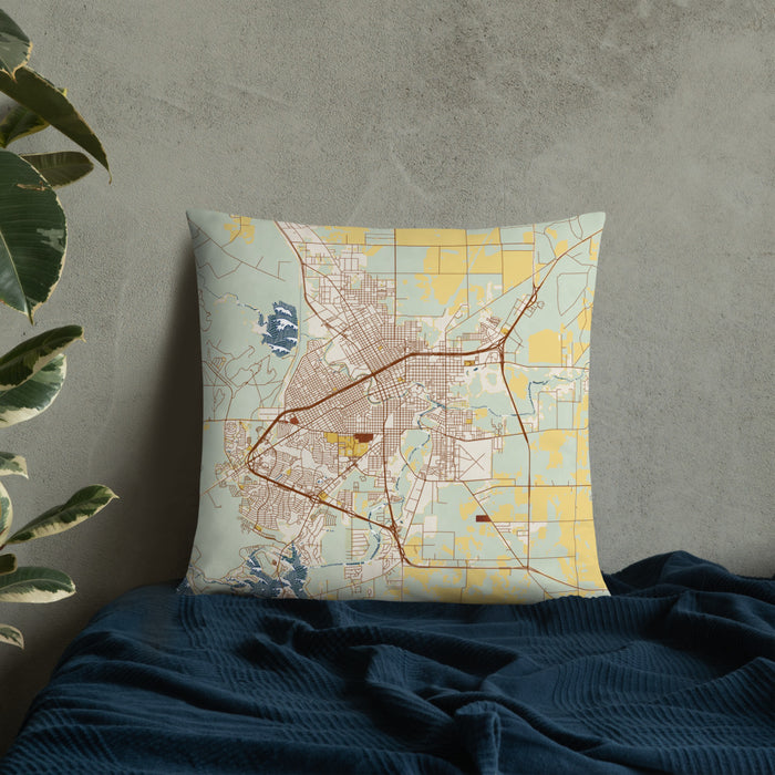 Custom San Angelo Texas Map Throw Pillow in Woodblock on Bedding Against Wall