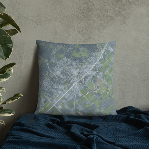 Custom San Marcos Texas Map Throw Pillow in Afternoon on Bedding Against Wall